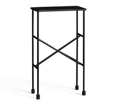 a black metal table with two legs and a shelf on the top that has an iron frame