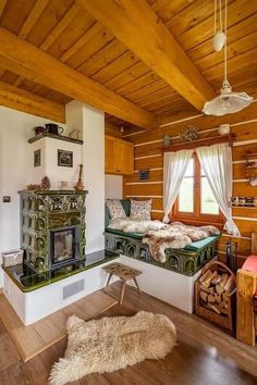 the interior of a log cabin with two beds and a fire place in the corner