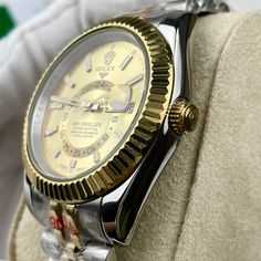 This timepiece is a Rolex Sky-Dweller, distinguished by its two-tone Oystersteel and 18ct yellow gold construction. The champagne dial features the iconic off-center 24-hour disc for dual time zone display, and an annual calendar. The watch is powered by the Calibre 9001, a complex self-winding mechanical movement. The fluted bezel, Oyster bracelet with Easylink extension, and Superlative Chronometer certification exemplify Rolex's commitment to precision and luxury. This Sky-Dweller is a sophis Formal Yellow Automatic Watch, Luxury Yellow Watches With Subdials, Timeless Yellow Chronometer Watch, Timeless Yellow Watch With Chronometer, Luxury Yellow Watch With Subdials, Gold Chronometer Watch Accessories With Round Dial, Classic Yellow Chronometer Watch, Gold Chronometer Watch With Round Dial, Timeless Watch With Day-date Display