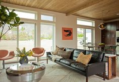 a living room filled with furniture and lots of windows