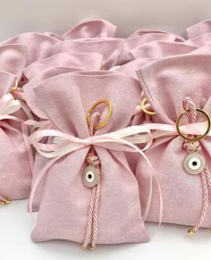 several pink bags with gold rings tied to them