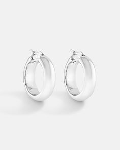 A chunky style hoop with a classic mid-size rounded design. The silver metal looks clean with each earring hand polished to perfection to gives it a luxurious shine. Even though the earrings are chunky, but the weight is controlled to maximize comfort even during long hours of wearing. The earrings are constructed in 18K yellow gold or white gold plated over sterling silver. Bamboo Hoop Earrings, Chunky Hoop Earrings, Long Hours, Mid Size, Round Design, Earring Sale, Ear Jewelry, Silver Hoop Earrings, Post Earrings