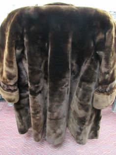 Here is a very Beautiful 3/4 length chocolate fur coat. The coat is in amazing condition. However there is some damage to the liner, This does not affect the wear ability of this very nice Mink. The tag inside the collar is torn out and the seam has come loose on the right side. Again easy fix along the seams, see pics. Since the tag is missing there is no way to know the maker or size. I can say that the measurement from armpit seam to armpit seam is 22" and the length of sleeve from shoulder t Classic Brown Fur Coat With Faux Fur Trim, Classic Brown Long Fur Coat, Classic Long Brown Fur Coat, Fur Coat Fashion, Winter Fur Coats, The Maker, Chocolate Brown, Right Side, No Way