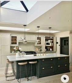 a kitchen with an island and two stools