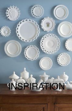 there are many white plates on the wall