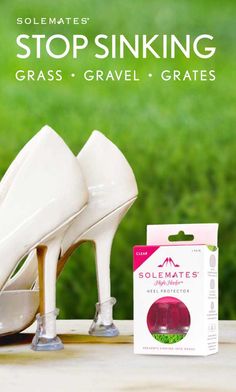 a pair of white high heels sitting on top of a table next to a package