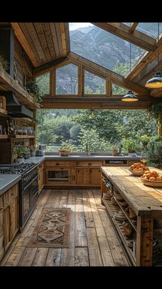 an outdoor kitchen with wooden floors and walls, windows on both sides that look out onto the mountains