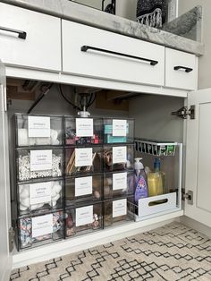 an organized pantry with clear bins and labels