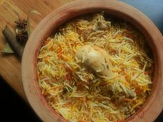 a wooden bowl filled with food on top of a table