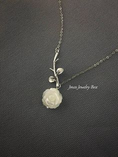 Sweet white shell rose and silver branch necklace. Very dainty but sturdy. White shell rose is double sided and 12mm wide. Silver branch and rose are on an 18'' stainless steel chain with lobster clasp. *Stainless steel chain *Silver brass branch *12mm Shell rose *Handmade with love <3 Like Jmesjewelrybox on Facebook for updates on new jewelry, upcoming sales and giveaways! Plus Facebook fans save 5% :D Find the coupon code on Jmesjewelrybox's cover photo https://www.facebook.com/Jmesjewelryb Elegant Silver Necklace With Rose Design, Silver Dainty Necklace With Rose Design, Dainty Silver Necklace With Rose Design, Dainty Silver Necklaces With Rose Design, Dainty Silver Rose Design Necklaces, Silver Flower-shaped Necklace With Rose Design, Silver Flower Necklace With Rose Design For Gift, Silver Rose Design Flower Necklace As Gift, Silver Rose Design Flower Necklace For Gift