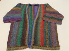 This multi color sweater has a nice kimono style.  It measures 22" shoulder to shoulder.  It's length is 26" long.  Sleeves are 9" long from shoulder. Bohemian Stretch Sweater For Winter, Bohemian Stretch Sweater For Fall, Long Multicolor Sweater For Fall, Multicolor Long Sweater For Fall, Multicolor Stretch Sweater For Fall, Multicolor Winter Outerwear With Kimono Sleeves, Winter Multicolor Outerwear With Kimono Sleeves, Casual Tops With Kimono Sleeves For Fall, Casual Fall Tops With Kimono Sleeves