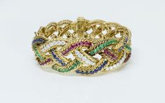 Boucheron Paris Emerald Ruby Sapphire Diamond Gold Bracelet1960's Vintage Boucheron Paris fine quality with emeralds, rubies, and round brilliant diamonds set in 18K yellow gold braided design.Weight: 99.5 GramsApproximate Measurements: Length 6.5" Width: 1"Condition: Excellent Boucheron Bracelet, Diamond Gold Bracelet, Paris Bracelet, 18k Gold Bracelet, Costume Jewelry Earrings, Ruby Sapphire, Diamond Gold, Brilliant Diamond, Sapphire Diamond