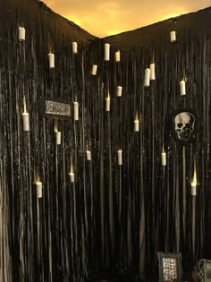 the wall is decorated with candles and skulls on it's sides, along with other decorations