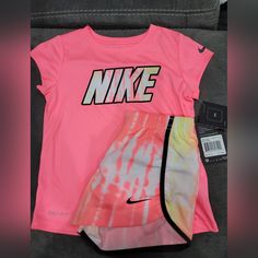 Nike Short And Tshirt Set, Size 6 Cute Pink Sports Tops, Nike Pink Tops With Letter Print, Pink Nike Tops With Letter Print, Nike Sporty Pink T-shirt, Sporty Pink Top For Playwear, Sporty Pink Tops For Playwear, Sporty Pink Nike T-shirt, Pink Graphic Print T-shirt For Playwear, Pink Graphic T-shirt For Playwear