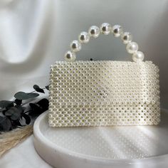 ❤  About this item; ● Pearl handbag will add elegance to your outfit from day to night. ● The beads used in its construction consist of high quality plastic pearls. Even if you use it for years, it does not deform in any way and preserves its first day appearance. At the same time, the threads used for knitting do not break and deform in any way. ● You can easily use the bags for years. 📌 Size Width: 8.66 inch (22 cm) Length together with handle: 8 inch (20.5 cm) Depth: 2.95 inch (7.5 cm) ❤  Find Details; ● High quality, non-fading pearl beads. ● It fits all the products you take with you on a daily basis such as iphone, wallet, perfume, makeup, keychain. 🚚 Shipping and Packaging - All orders will be sent by express shipping with tracking.  - If you want to order for a specific day, just Cream Top Handle Party Bag, Cream Top Handle Bag For Party, Everyday Handheld Pearl Shoulder Bag, Rectangular Bags With Pearl Embroidery, Party Cream Top Handle Bag, Rectangular Evening Bag With Pearl Handle, Beige Handheld Shoulder Bag With Pearl Handle, Cream Top Handle Party Bags, Pearl Handheld Bag As Gift