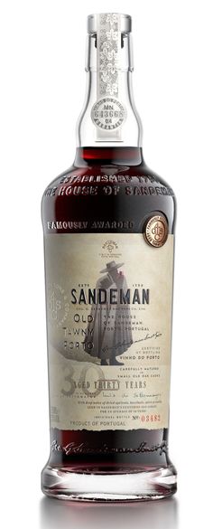 a bottle of sandeman old curiosity blended whisky on a white background with an aged paper label