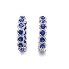 Stylish hoop 18k white gold earrings with blue sapphires and diamonds. Sapphires are round cut Ceylon blue gems 13.58 ct total. Accented by white round diamonds 3.98 ct in total. Diamonds are white and natural and in G-H Color Clarity VS. 18k white gold Length: 3 cm diameter Weight: 15 g [shortcode] [video] [/video] [/shortcode] Blue Hoop Earrings With Prong Setting, Blue Diamond Round Hoop Earrings, Blue Diamond Hoop Earrings, Formal Blue Round Hoop Earrings, Blue Round Hoop Earrings For Formal Occasions, Blue Diamond Hoop Earrings Fine Jewelry, Sapphire Round Hoop Earrings Fine Jewelry, Sapphire Hoop Earrings Fine Jewelry, Blue Cubic Zirconia Hoop Earrings