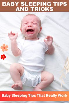 a baby laying on top of a bed with its mouth open