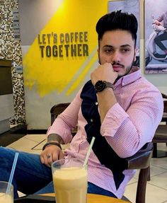 a man sitting at a table with a drink in front of him and the words let's coffee together