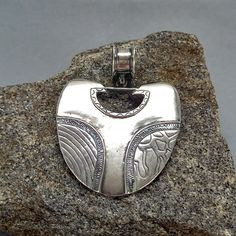 A unique handcrafted necklace made of 925 sterling silver, featuring a boho hippie pendant with a geometric ethnic tribal design. This artisan jewelry piece is truly one of a kind, perfect for those who appreciate distinctive and elegant accessories. * 100% polished solid sterling silver * .925 trademark stamp Sterling  Silver * Solid sterling silver weight: approx. 7.5 Grams * Length: 60 mm  / 2.36 inches  *  Width: 45 mm  / 1.77 inches * Inner Bail diameter: 10 mm / 0.38 inches * Solid sterlin Artisan Silver Engraved Necklaces, Handmade Artisan Antique Silver Necklace, Unique Engraved Pendant Necklace, Artisan Silver Heart Pendant Necklace, Artisan Sterling Silver Necklace For Festival, Sterling Silver Nickel-free Necklace For Festivals, Unique Silver Festival Jewelry, Artisan Silver Nickel-free Necklace, Nickel-free Silver Artisan Necklace