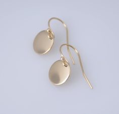 "14K solid gold earrings. 14K solid gold tiny disc earrings. Tiny gold disc earrings. Simple earrings. Dainty earrings. Gift for her. These earrings are simple and can be worn everyday. * 14K solid gold disc is 3/8\", 22 gauge. Please select yellow gold or white gold. * 14K solid gold ear wire The earrings will be shipped in a nice gift box. To see add-on click on the link below. https://www.etsy.com/shop/SashJewelry?section_id=12359884 To see more children's jewelry click on the link below. htt 14k Yellow Gold Circle Earrings, Dainty Recycled Gold Earrings, Dainty Circle Earrings In 14k Gold, Yellow Gold Rounded Earrings For Gift, Yellow Gold Earrings Gift, Dainty 14k Gold Circle Earrings, 14k Gold Circle Earrings For Gifts, Minimalist 14k Gold Filled Earrings With Polished Finish, Minimalist 14k Gold Filled Polished Earrings