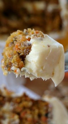 a close up of a spoonful of food with some ice cream on it's tip