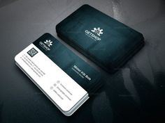 two business cards sitting next to each other on top of a black table with white trim