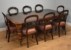 a dining room table with six chairs around it