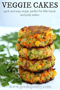 three crab cakes stacked on top of each other in front of some parsley leaves