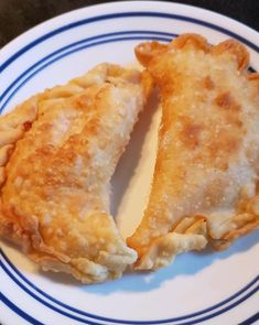 two pieces of pie sitting on top of a blue and white plate