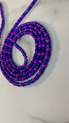 Handcrafted waist beads in our blue and purple. All waist beads are made with glass seed beads. Our tie-on waist beads come with cotton beading string from Ghana, and our removable clasp, options comes with our extra strong elastic threading. All waist beads are made to order.  Our waist beads come in the traditional tie-on method and a clasp method. The tie-on method is for permanent everyday wear. The clasp method is for the unicorns who like to be versatile and take their waist beads off whenever they choose.  MEASURING YOUR WAIST Please measure your waist in the area where you would like your waist beads to fall. Waist beads can be worn at the hipline and the natural waistline.  After measuring your waist please add at least a one to a two-finger gap for a comfortable fit. Blue Colorful Waist Beads As Gift, Blue Beaded Waist Beads As Gift, Blue Waist Beads With Spacer Beads As Gift, Blue Round Beads Waist Beads For Gift, Blue Waist Beads Gift, Adjustable Blue Waist Beads For Beach, Blue Beaded Waist Beads, Blue Round Beads Waist Beads For Festival, Handmade Blue Waist Beads As Gift