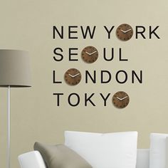 there is a clock on the wall in this living room that says new york seul london tokyo