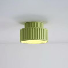 a green light fixture hanging from the ceiling