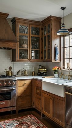 a kitchen with wooden cabinets and an area rug in front of the stove top oven