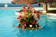 a flower arrangement in the middle of a pool