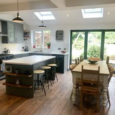 a large kitchen with an island table and chairs