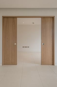 an empty room with two wooden doors open