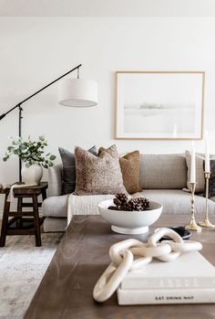 a living room filled with furniture and a white bowl on top of a coffee table