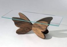 a glass table with a wooden butterfly on it