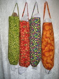 four bags with fruits in them are lined up