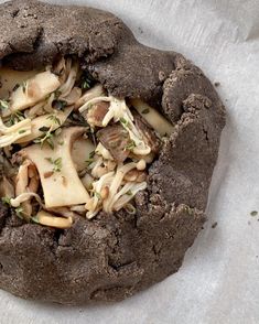 a close up of a chocolate cookie with toppings on it's crusty surface