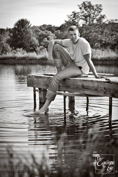 a man sitting on a dock in the water