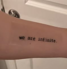 a person's arm with the words we are infinite written in cursive font