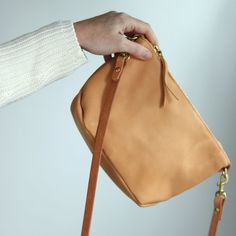 This versatile small beige leather handbag is the perfect bag to travel with on your next trip! It's handmade with vegetable tanned leather and a premium zipper, and has a removable strap so you can also use it as a clutch! This timeless women's bag will become a staple in your capsule wardrobe and is made to last. Everyday Phone Bag Clutch With Cell Phone Pocket, Versatile Everyday Mobile Phone Pouch, Everyday Versatile Mobile Phone Pouch, Everyday Pouch Satchel With Cell Phone Pocket, Everyday Phone Bag With Cell Phone Pocket, Everyday Crossbody Satchel With Cell Phone Pocket, Modern Crossbody Pouch For Everyday Use, Versatile Leather Mobile Phone Pouch, Everyday Mobile Phone Shoulder Pouch