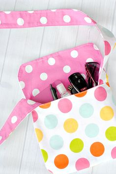 a polka dot purse with various items in it