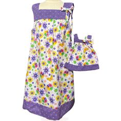 a child's apron and bib set with flowers on the front, purple trim