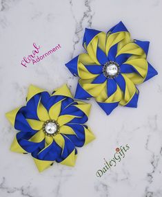 two blue and yellow flower hair clips on a marble surface