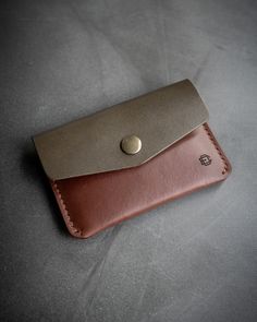 Our olive + brown snap card wallet is made from buttery smooth, Wickett & Craig English Bridle Leather. This full grain, vegetable tanned leather will look even better with age and use. All edges have been hand burnished to a smooth, satin finish. Features a main card slot, with a brass snap closure, that can accommodate 8-10 cards. There is an additional outer back pocket for quick access to 1 or 2 important cards. 4″ Wide x3″ High x .3″ Thick. Each piece is hand made and hand sewn in the USA. Brown Wallet With Coin Pocket In Vegetable Tanned Leather, Brown Vegetable Tanned Leather Wallet With Coin Pocket, Brown Vegetable-tanned Trifold Wallet For Daily Use, Brown Vegetable Tanned Leather Wallet For Everyday Use, Brown Vegetable Tanned Leather Wallets For Everyday Use, Brown Vegetable-tanned Leather Wallets For Everyday Use, Brown Vegetable Tanned Leather Wallet With Card Slots, Brown Vegetable Tanned Leather Wallets For Everyday, Brown Rectangular Vegetable Tanned Leather Wallet