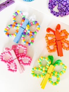 three different types of beaded butterfly brooches on a white surface next to scissors and beads