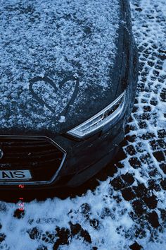 a car is covered in snow on the street